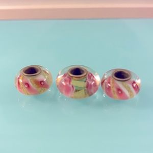 Three Bella Perlina pink, green and yellow glass beads. One large, two smaller